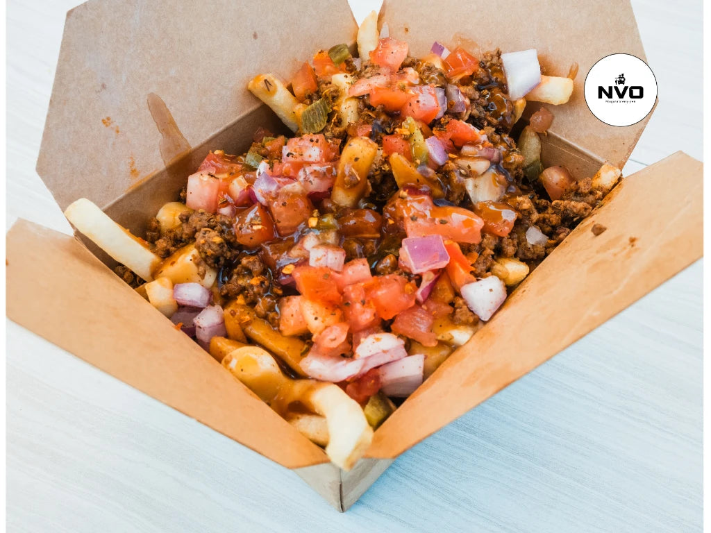 "Crispy golden fries topped with melted cheese curds and smothered in rich, piping hot gravy, served in a rustic wooden bowl."